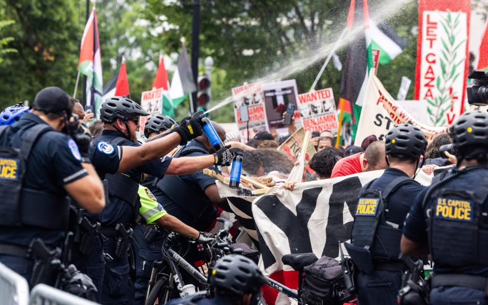 Police pepper spray anti-Israel protesters outside the US Capitol