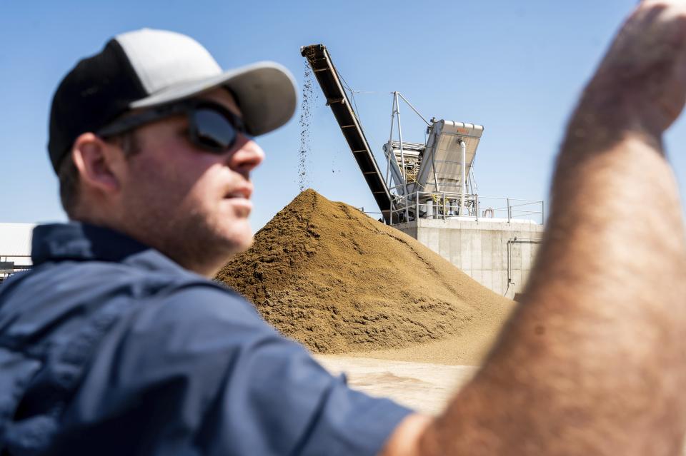 A separator removes solids from cow manure as Wickstrom Jersey Farms manager Brent Wickstrom discusses his farm's dairy digester on Thursday, May 9, 2024, in Hilmar, Calif. The farm uses a diary digester to capture methane from cow manure which generates energy in an effort to reduce greenhouse gas emissions. (AP Photo/Noah Berger)