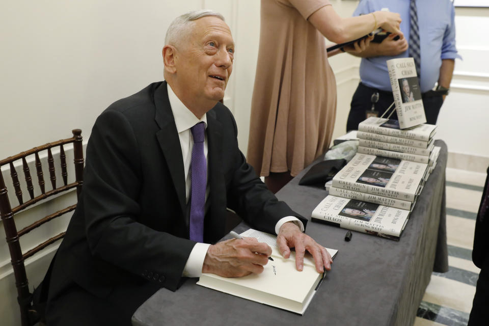 Former U.S. Secretary of Defense Jim Mattis signs copies of his book after he spoke at the Council on Foreign Relations, in New York, Tuesday, Sept. 3, 2019. (AP Photo/Richard Drew)