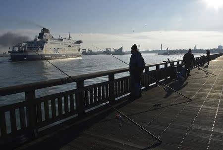 A Channel Ferry passes fishermen on Calais harbour wall as it arrives from Britain, in Calais, France, January 20, 2016. REUTERS/Toby Melville