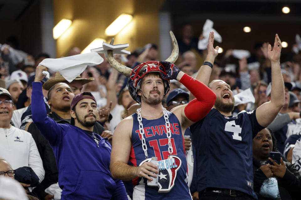 Houston Texans fans cheer during the second half of an NFL football game against the Dallas Cowboys , Sunday, Dec. 11, 2022, in Arlington, Texas. (AP Photo/Michael Ainsworth)