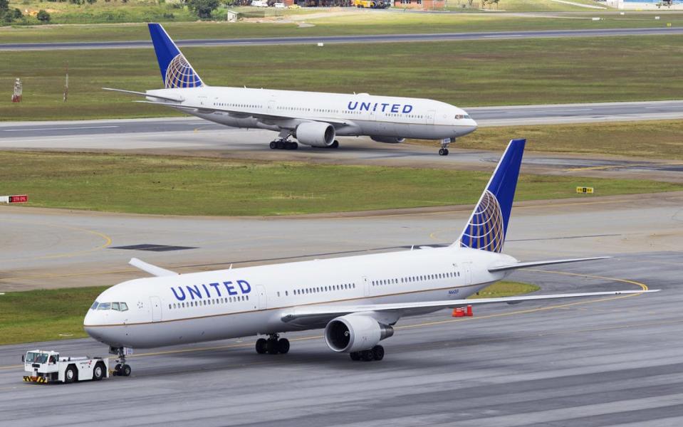 Two United Airlines planes on a runway