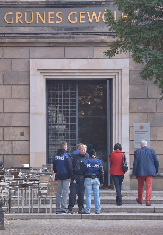 Policemen stand outside the Green Vault city palace after a robery in Dresden