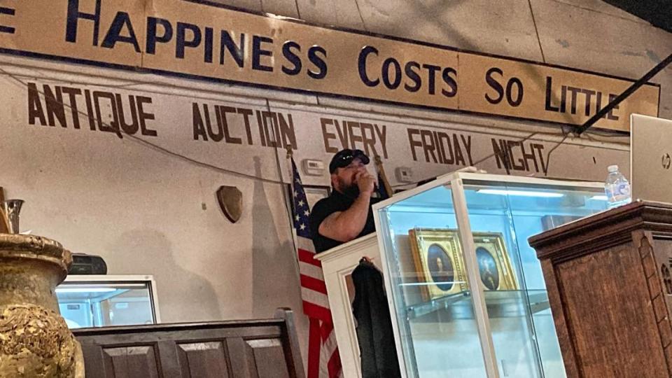 An auctioneer takes bids for items at the Mebane Antique Auction Gallery Saturday, March 25, 2023. Among the nearly 500 items for sale that day was a small skull purporting to be from North America circa 1400, drawing protests from Native American groups.