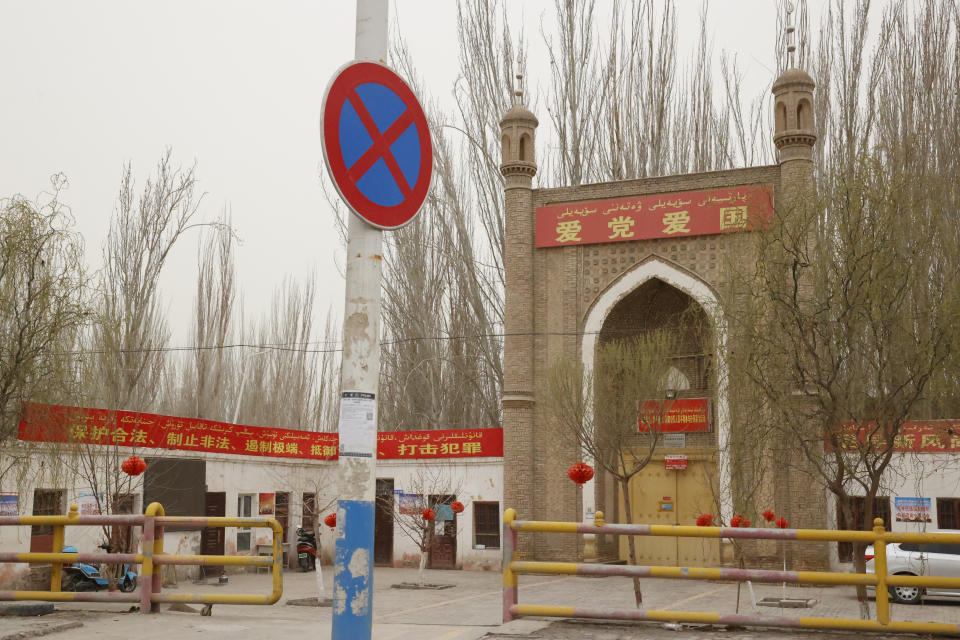 A mosque with the banner "Love the Party, Love the Country" is seen near Shule county in northwestern China's Xinjiang Uyghur Autonomous Region on March 20, 2021. Four years after Beijing's brutal crackdown on largely Muslim minorities native to Xinjiang, Chinese authorities are dialing back the region's high-tech police state and stepping up tourism. But even as a sense of normality returns, fear remains, hidden but pervasive. (AP Photo/Ng Han Guan)