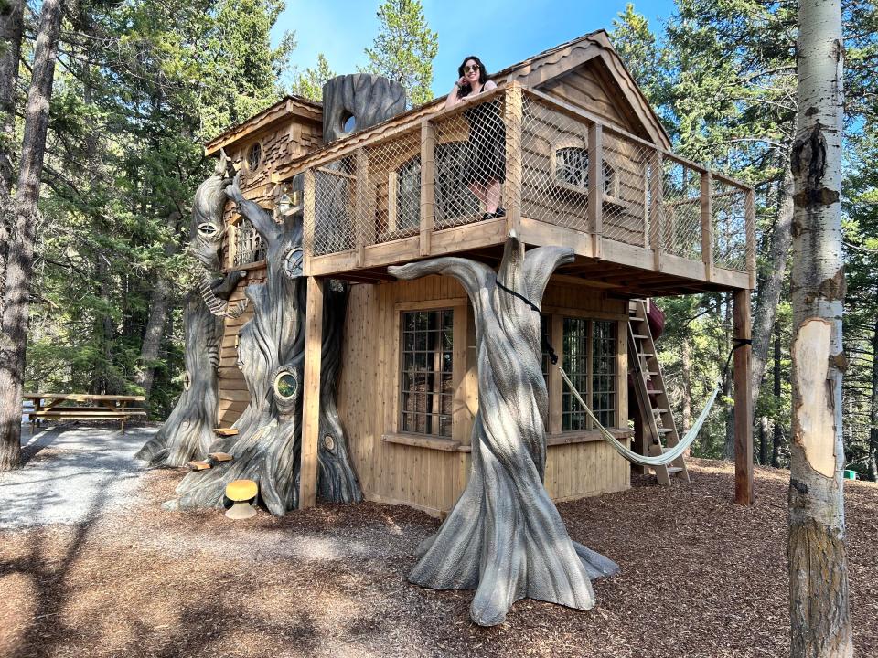 lost Boys Treehouse exterior, three floors and faux trees with paige on balcony