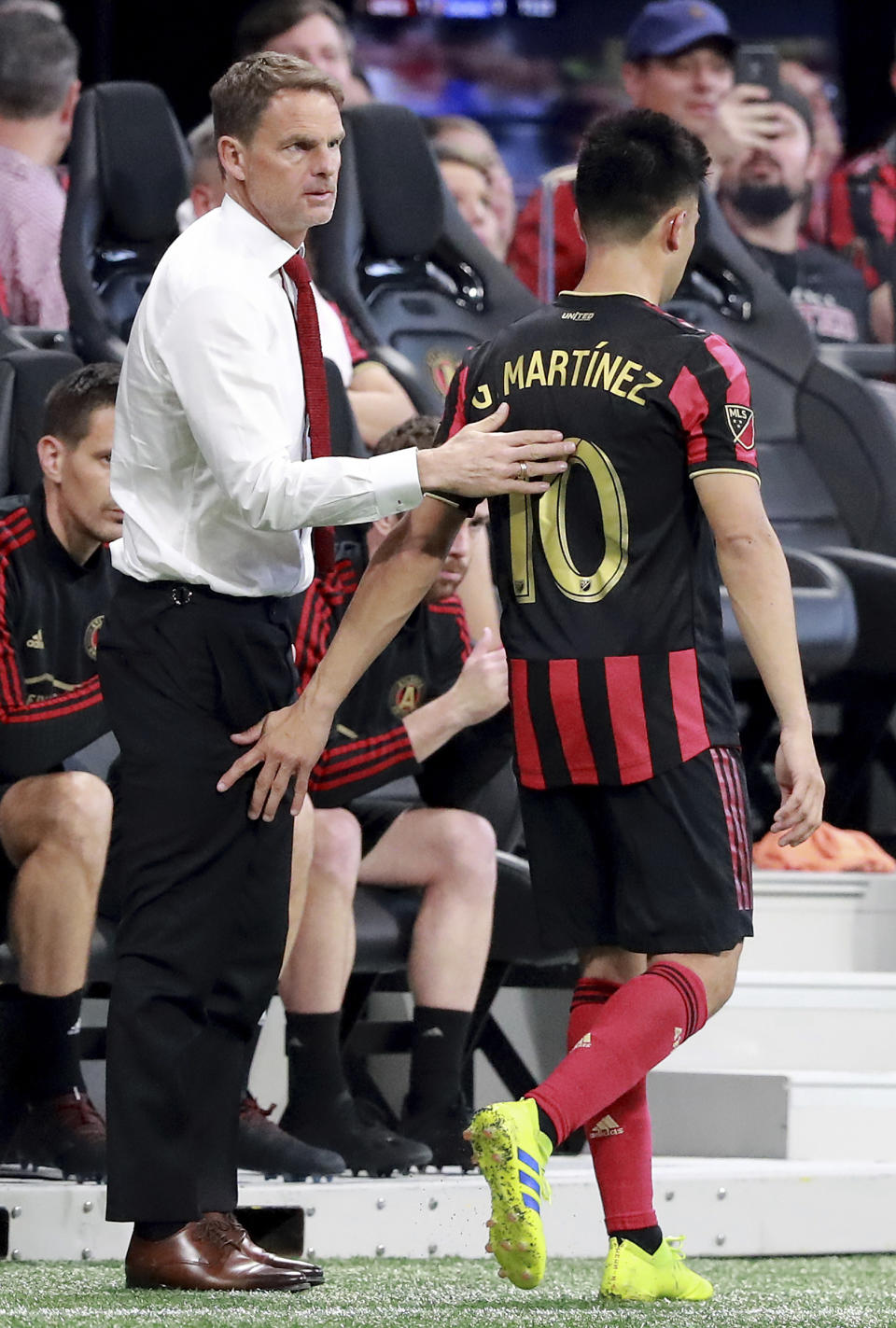 March 10, 2019 Atlanta: Atlanta United head coach Frank de Boer gives midfielder Pity Martinez a pat on the back as he pulls him from the game during the second half against FC Cincinnati in their MLS soccer match on Sunday, March 10, 2019, in Atlanta. (Curtis Compton/Atlanta Journal-Constitution via AP)