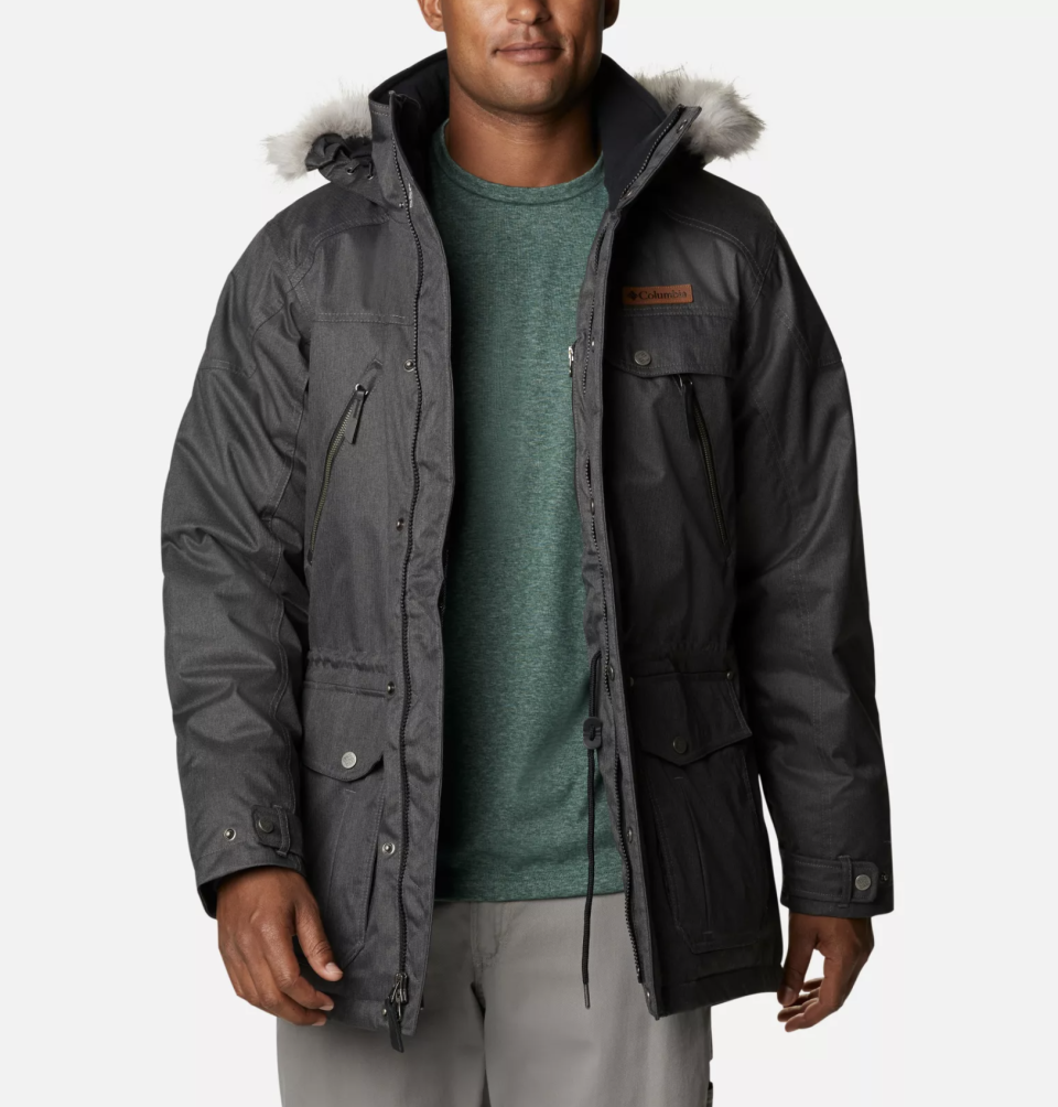 man wearing green sweater and black men's parka, Barlow Pass 550 TurboDown Jacket in Black (Photo via Columbia)