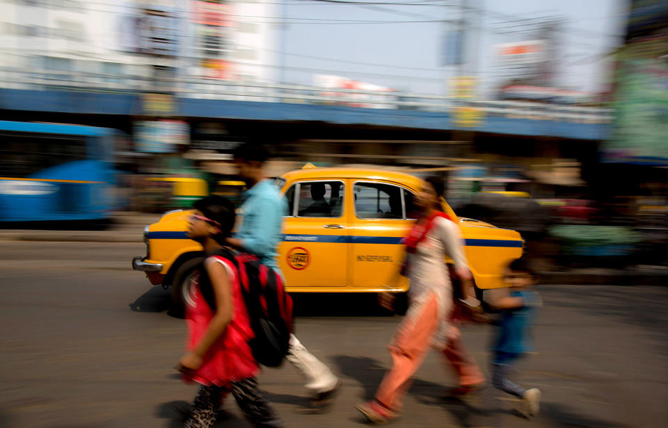 Taxi drives through a street in Calcutta