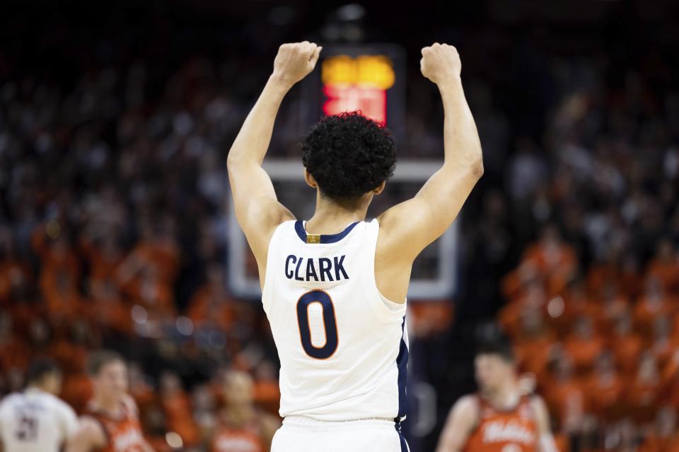 Virginia's Kihei Clark (0) celebrates during the first half of an NCAA college basketball game against Virginia Tech in Charlottesville, Va., Wednesday, Jan. 18, 2023. (AP Photo/Mike Kropf)