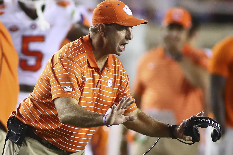 Clemson head coach Dabo Swinney tries to calm players during the third quarter of the team's NCAA college football game against Florida State on Saturday, Oct. 15, 2022, in Tallahassee, Fla. Clemson won 34-28. (AP Photo/Phil Sears)