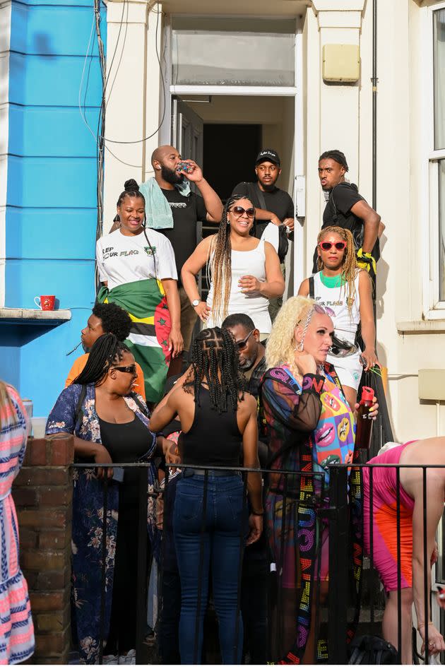 Onlookers watch the Notting Hill Carnival parade go down Ladbroke Grove. (Photo: Clara Watt for HuffPost)