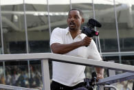 US actor Will Smith holds a camera prior to the start of the Emirates Formula One Grand Prix at the Yas Marina racetrack in Abu Dhabi, United Arab Emirates, Sunday, Nov. 25, 2018.(AP Photo/Luca Bruno)