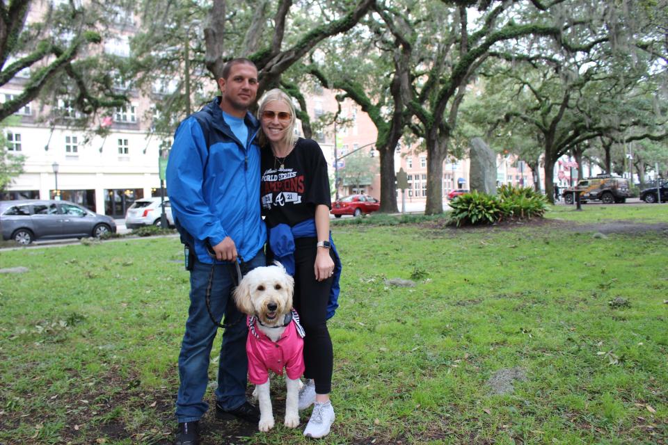 Stephanie Coursey and Patrick Strang walk their dog on Bay Street. The two from Atlanta are here to attend a wedding that was canceled in anticipation of Tropical Storm weather from Hurricane Ian.