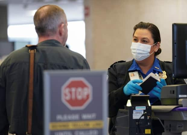 The U.S. announced on Monday that, come early November, foreign air passengers to the U.S. will have to show proof that they're fully vaccinated.   (Kevin Lamarque/Reuters - image credit)