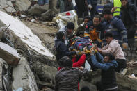 <p>People and emergency teams rescue a person on a stretcher from a collapsed building in Adana, Turkey, Monday, Feb. 6, 2023. A powerful quake has knocked down multiple buildings in southeast Turkey and Syria and many casualties are feared. (IHA agency via AP)</p> 