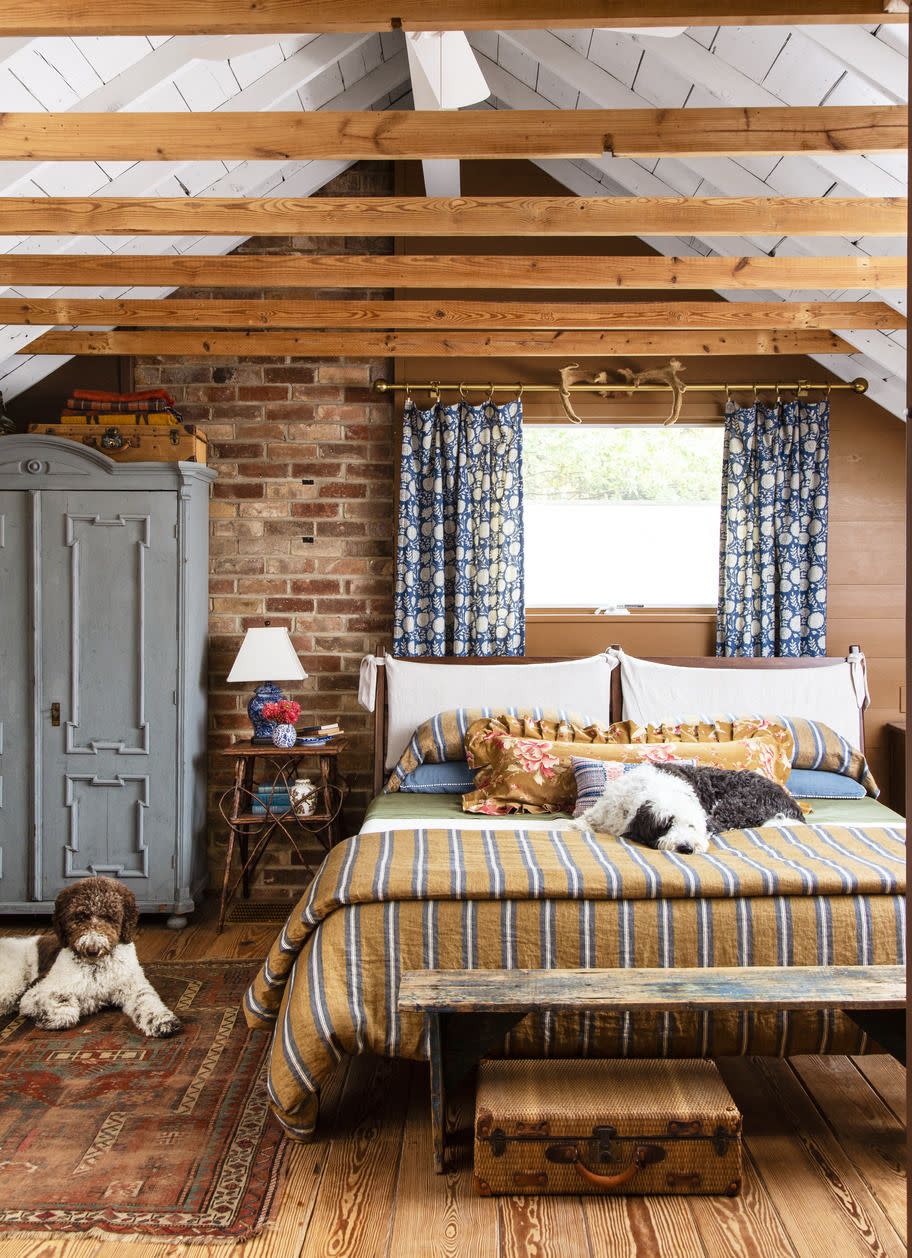 virginia mountain cottage bedroom with dogs on bed and bench at the end