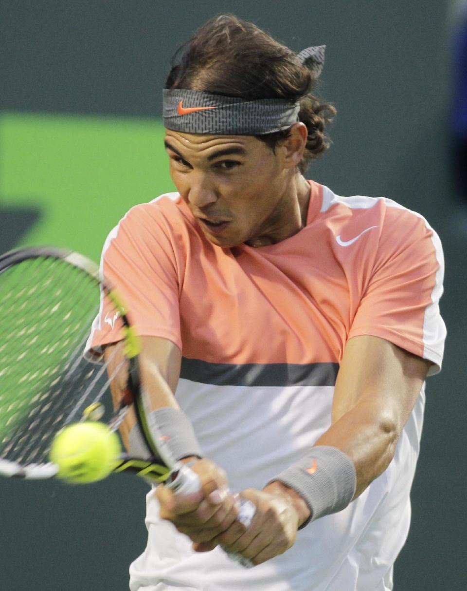 Rafael Nadal, of Spain, returns the ball to Milos Raonic, of Canada, during the Sony Open tennis tournament, Thursday, March 27, 2014, in Key Biscayne, Fla. (AP Photo/Luis M. Alvarez)
