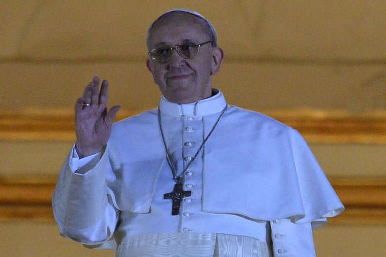 Argentina's Jorge Bergoglio, elected Pope Francis I, appears at the window of St Peter's Basilica after being elected the 266th pope of the Roman Catholic Church on March 13, 2013 at the Vatican