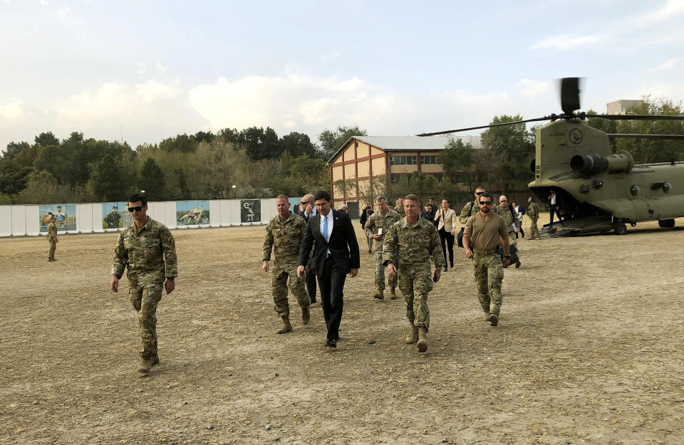 U.S. Defense Secretary Mark Esper, center, walks Gen. Scott Miller, right, chief of the U.S.-led coalition in Afghanistan, at the U.S. military headquarters in Kabul, Afghanistan, Sunday, Oct. 20, 2019. Esper arrived Sunday in Afghanistan, where stalled peace talks with the Taliban and persistent violent attacks by the insurgent group and Islamic State militants have complicated the Trump administration’s pledge to withdraw more than 5,000 American troops. He told reporters traveling with him that he believes the U.S. can reduce its force in Afghanistan without hurting the counterterrorism fight against al-Qaida and the Islamic State group. (AP Photo/Lolita C. Balbor)