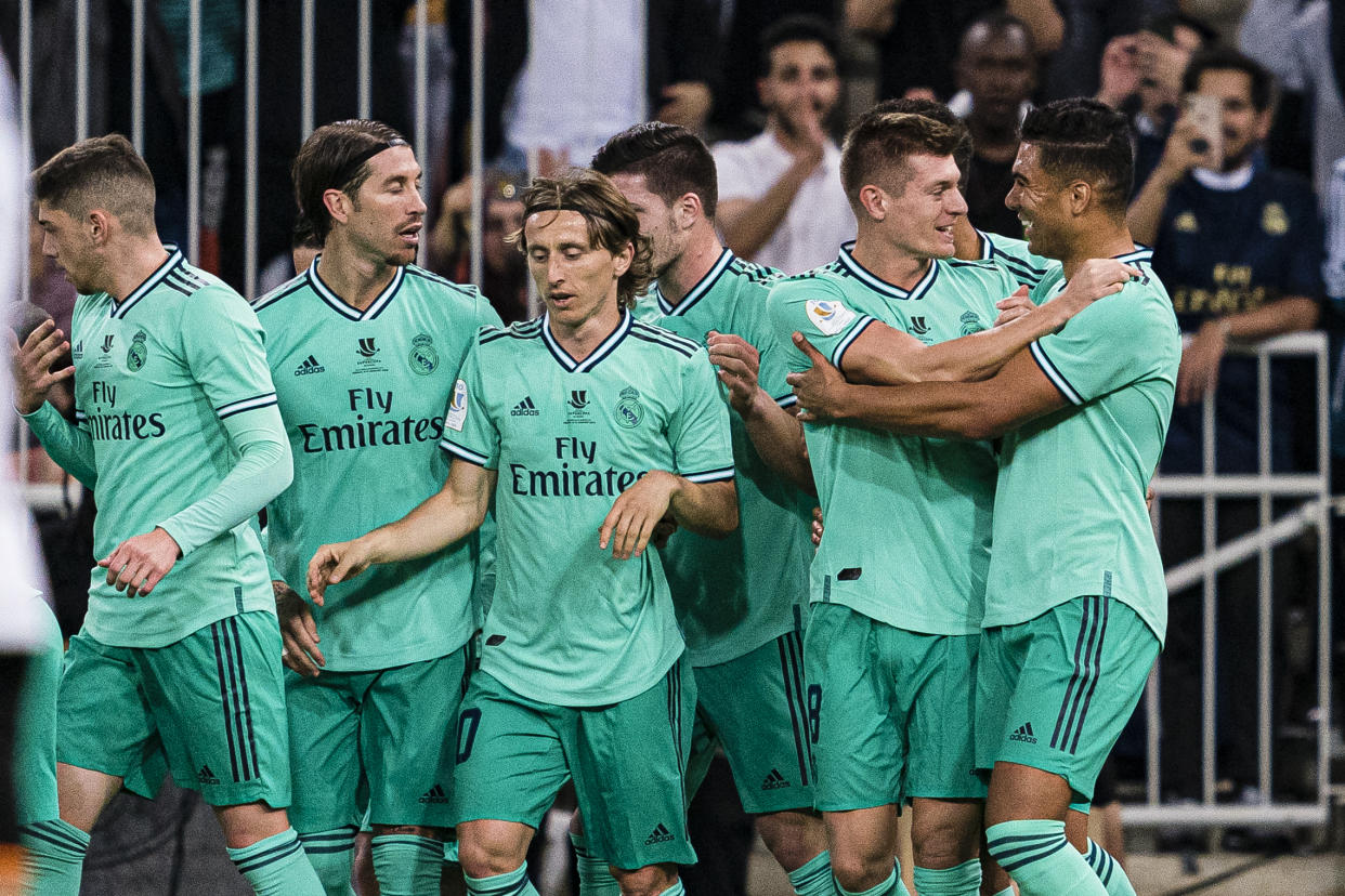 Toni Kroos (second from right) and his Real Madrid teammates celebrate after Kroos' opening goal against Valencia. (Photo by Ricardo Nogueira/Eurasia Sport Images/Getty Images)