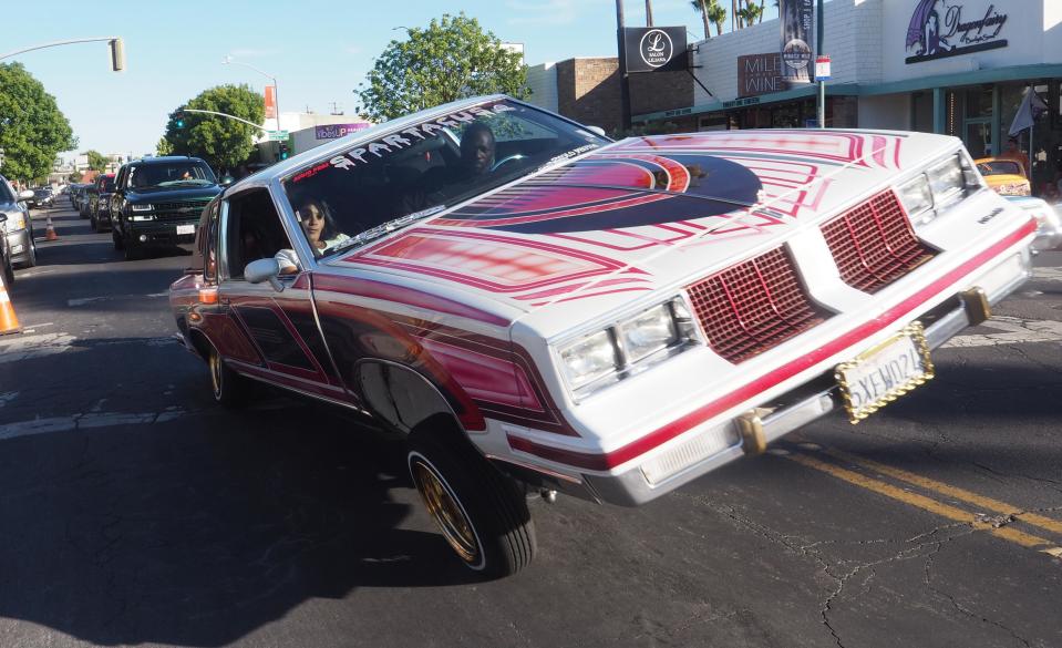 A late model car balances on two wheels during Stockton Cruise Night.