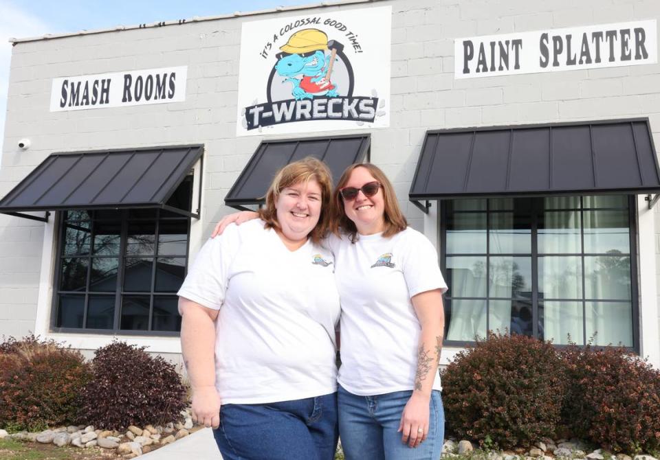 Heidi Inman, left, and Cheryl Yeager, co-owners of T-Wrecks Smash and Paint Splatter Rooms, stand in front of their store on East Main Street in Rock Hill.