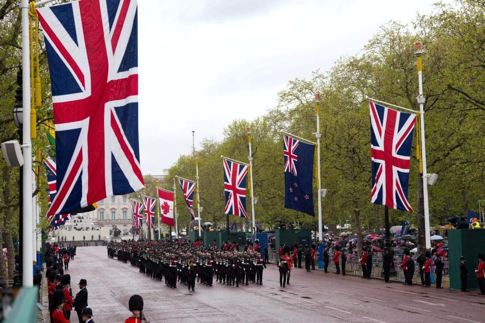 英軍儀仗隊在林蔭大道遊行，兩旁樹立英國以及大英國協國家的國旗，慶祝查爾斯三世加冕。路透社