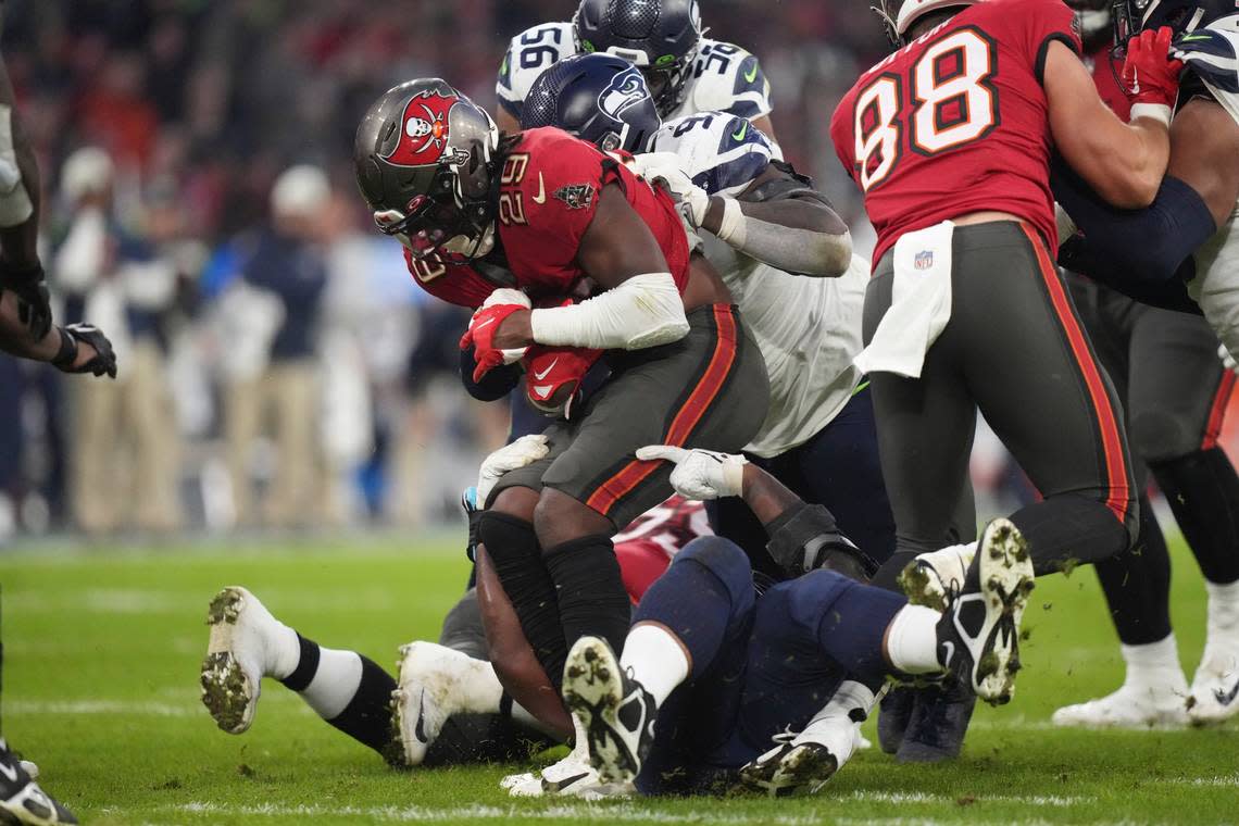 Tampa Bay Buccaneers’ Rachaad White is tackled during the first half of an NFL football game against the Seattle Seahawks, Sunday, Nov. 13, 2022, in Munich, Germany. (AP Photo/Matthias Schrader)