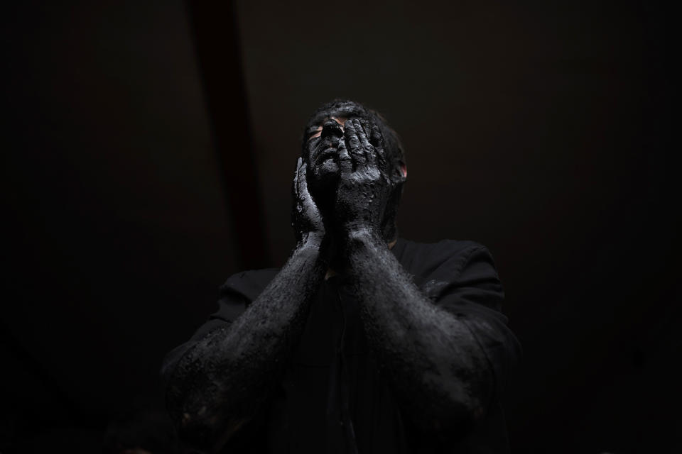 <p>A man covers his face in oil and soot as he prepares himself for a carnival festival in the small village of Luzon, Spain, March 1, 2014. (AP Photo/Andres Kudacki) </p>