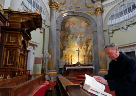 Miklos Beer, the bishop of Vac, reads a book in the cathedral in Vac, Hungary March 9, 2017. REUTERS/Laszlo Balogh