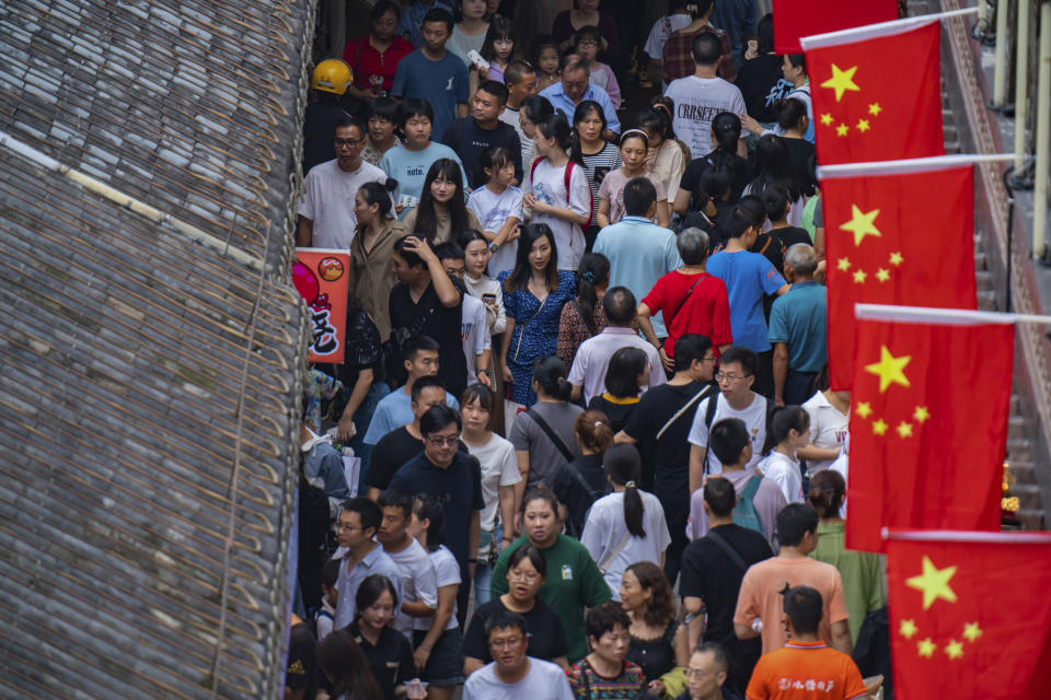 Tourists visit the Hongyadong scenic zone during the weeklong national holiday in southwest China's Chongqing municipality on Sept. 30, 2023. Tourism in China bounced back to pre-pandemic levels during a recent eight-day national holiday, giving a temporary boost to the nation's flagging economy. (Chinatopix via AP)