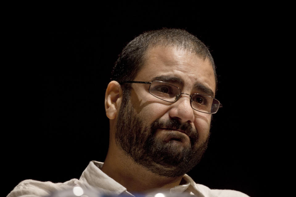 FILE - In this Sept. 22, 2014, file photo, Egypt's leading pro-democracy activist Alaa Abdel-Fattah takes a moment as he speaks about his late father Ahmed Seif, one of Egypt's most respected human rights lawyers, during a conference held at the American University in Cairo, Egypt. An Egyptian court placed nearly 30 people, including Abdel-Fattah and an Islamist politician, on a terrorism watch list over accusations they joined the banned Muslim Brotherhood, the official gazette reported Monday, Nov. 23, 2020. (AP Photo/Nariman El-Mofty, File)