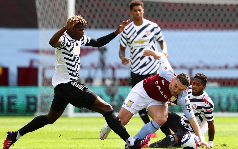 John McGinn of Aston Villa battles for possession with Paul Pogba of Manchester United - Getty