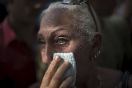 Vendor Lereida Sanchez, 54, cries during a protest near the Ecuadorean embassy a day after the announcement that Cubans would need visas to enter Ecuador as of December 1, Havana, November 27, 2015. REUTERS/Alexandre Meneghini