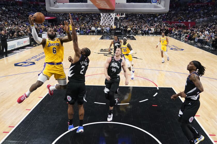 Los Angeles Lakers forward LeBron James (6) shoots over Los Angeles Clippers forward Kawhi Leonard (2) during the second half of an NBA basketball game Wednesday, April 5, 2023, in Los Angeles. (AP Photo/Marcio Jose Sanchez)