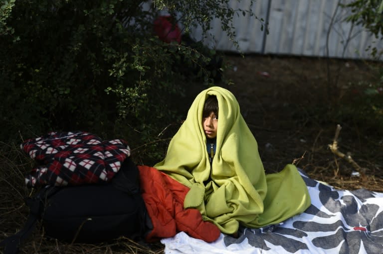 A refugee from Afghanistan waits outside the State Office of Health and Social Affairs in Berlin on September 29, 2015