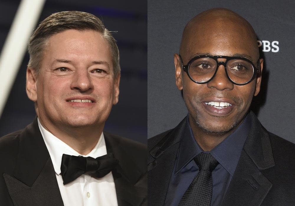 In this file photo combo, Netflix chief Ted Sarandos, left, appears at the Vanity Fair Oscar Party in Beverly Hills, Calif., on Feb. 24, 2019, and comedian Dave Chappelle, right, arrives at Kennedy Center for the Performing Arts to receive the 22nd Annual Mark Twain Prize for American Humor in Washington on Oct. 27, 2019. (AP Photo, File)