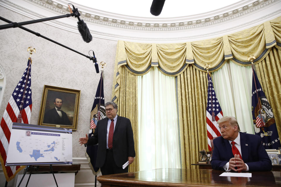 Attorney General William Barr, left, speaks during a law enforcement briefing on the MS-13 gang with President Donald Trump in the Oval Office of the White House, Wednesday, July 15, 2020, in Washington. (AP Photo/Patrick Semansky)