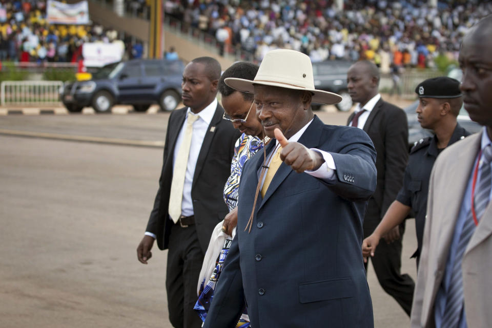 Uganda's President Yoweri Museveni arrives at an anti-gay rally organized by a coalition of Ugandan religious leaders and government officials, at the Kololo Independence Grounds in Kampala, Uganda, Monday, March 31, 2014. President Yoweri Museveni of Uganda has launched fresh condemnation of gays, saying they deserve punishment because homosexuality "is criminal and it is so cruel." Museveni, who last month signed a bill strengthening criminal penalties against homosexuals, said Monday that he is "now mobilizing to fight" Western gays he accuses of promoting homosexuality in Africa. (AP Photo/Rebecca Vassie)