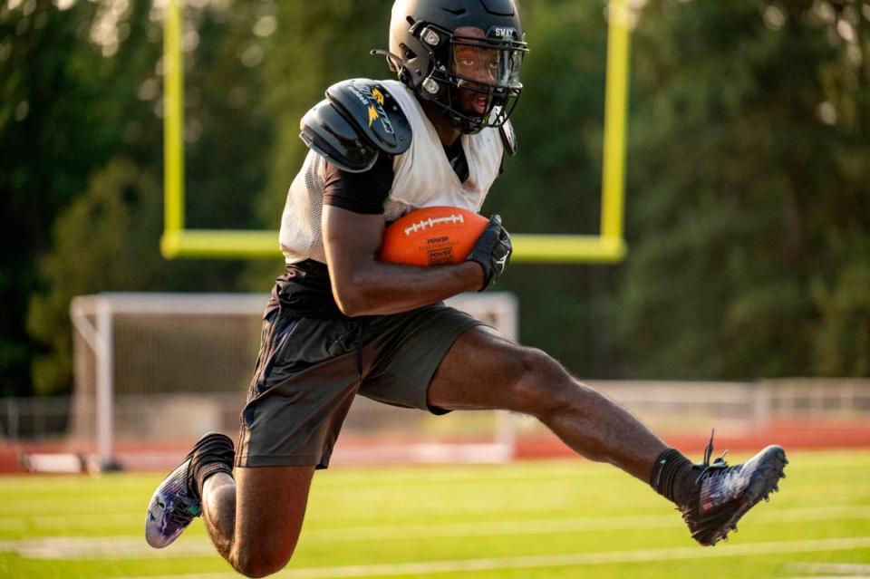 Spanaway Lake running back D’aryhian Clemons leaps over pads during drills at during practice on Wednesday, Aug. 23, 2023, at Spanaway Lake High School in Spanaway, Wash.