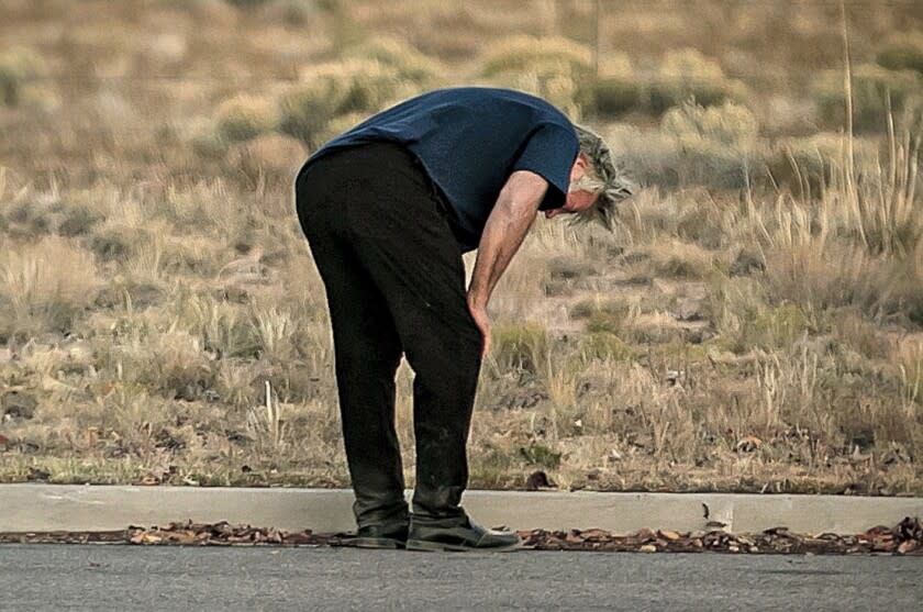 A distraught Alec Baldwin lingers in the parking lot outside the Santa Fe County Sheriff's Office in Santa Fe, N.M., after he was questioned about a shooting on the set of the film "Rust" on the outskirts of Santa Fe, Thursday, Oct. 21, 2021. Baldwin fired a prop gun on the set, killing cinematographer Halyna Hutchins and wounding director Joel Souza, officials said. (Jim Weber/Santa Fe New Mexican via AP)