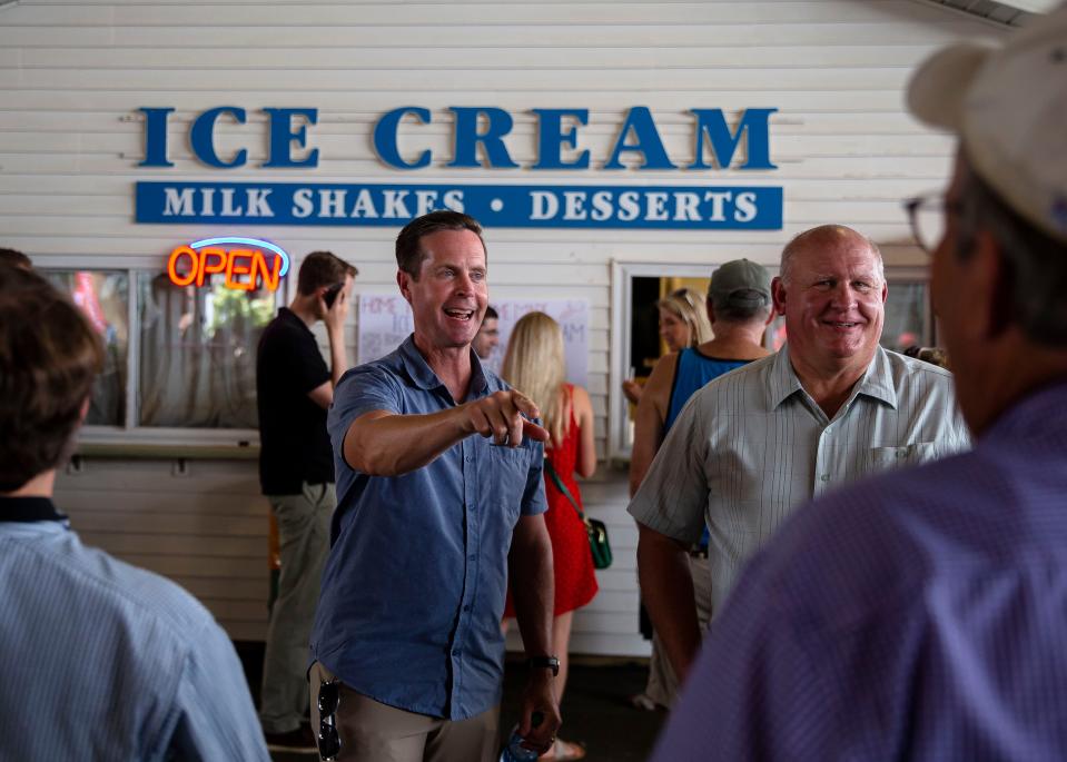 U.S. Rep. Rodney Davis, R-Ill., left, and U.S. Rep Glenn 'GT' Thompson, R-Pa., right, talk with visitors in line as they get ice cream in the Commodities Pavilion during the 2021 Illinois State Fair at the Illinois State Fairgrounds in Springfield, Ill., Tuesday, August 17, 2021. [Justin L. Fowler/The State Journal-Register] 