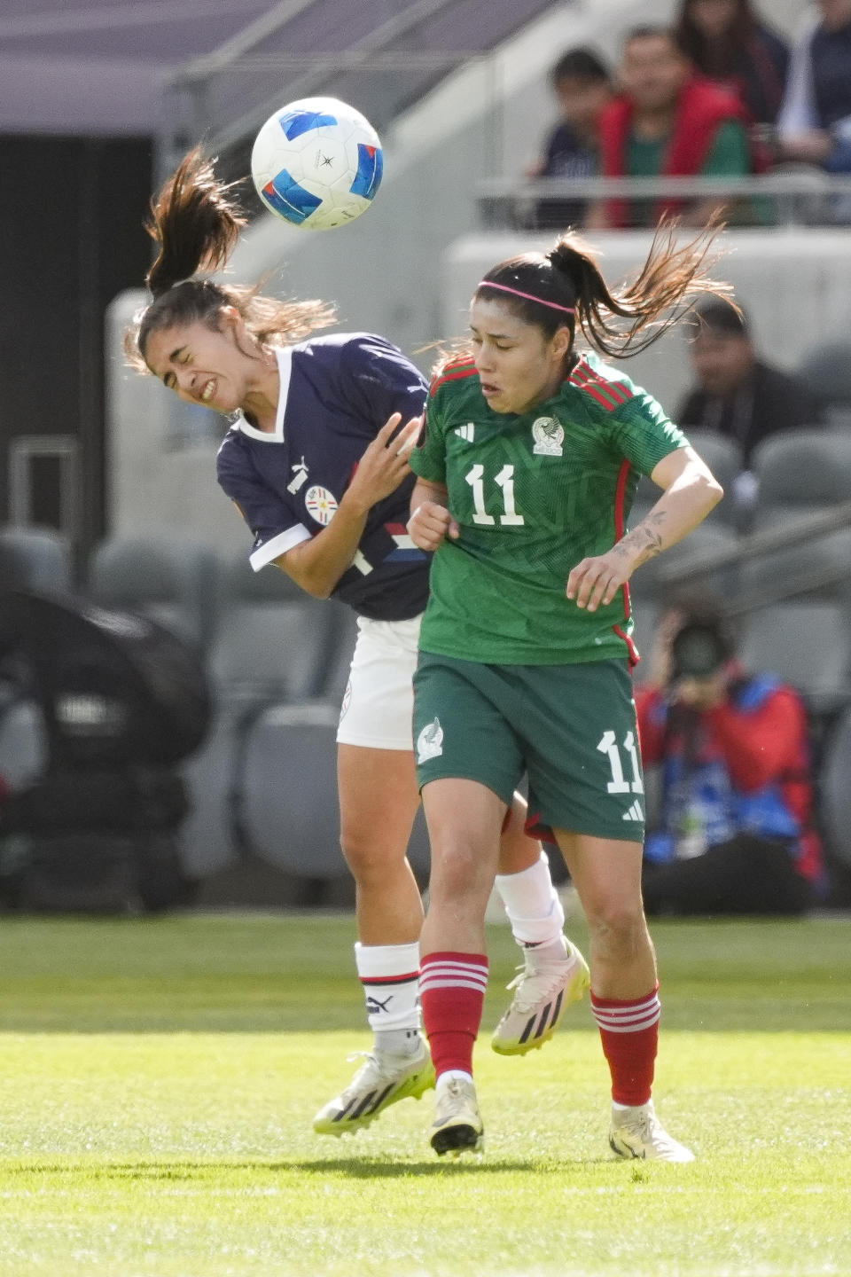 Mexico midfielder Jacqueline Ovalle, right, works for a head ball against Paraguay defender Daysy Bareiro during the first half of a CONCACAF Gold Cup women's soccer tournament quarterfinal, Sunday, March 3, 2024, in Los Angeles. (AP Photo/Marcio Jose Sanchez)