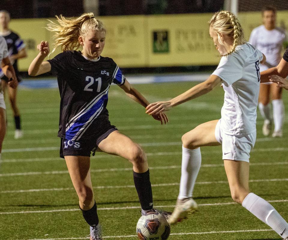 Lakeland Christian's KJ Straub battles McKeel's Madison Walsh battle for control of the ball during their Champions bracket semifinals match.