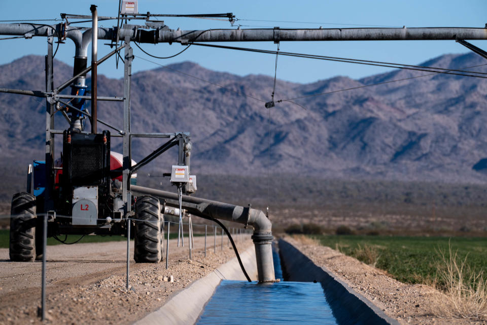 Ground water is pumped into a canal to irrigate a field, February 25, 2022, at Fondomonte's Butler Valley Ranch near Bouse.