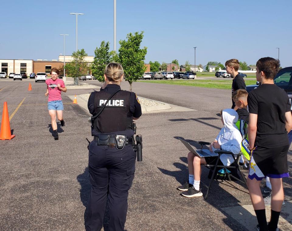 A student completes the radar run with the Watertown Police Department school resource office during the Watertown Middle School Arrowfest on Friday, May 26, 2023.