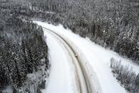 FILE - In this Feb. 16, 2021, file photo, a medical car carrying COVID-19 vaccines drives to the village of Ikhala in Russia's Karelia region. Russia’s boast in August that it was the first country to authorize a coronavirus vaccine led to skepticism because of its insufficient testing on only a few dozen people. Now, with demand growing for the Sputnik V, experts are raising questions again, this time over whether Moscow can keep up with all the orders from countries that want it. (AP Photo/Dmitri Lovetsky, File)