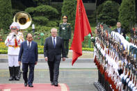 Australian Prime Minister Scott Morrison, center, with his Vietnamese counterpart Nguyen Xuan Phuc reviews an honor guard during a welcome ceremony at the Presidential Palace in Hanoi, Vietnam, Friday, Aug. 23, 2019. Morrison is on a three-day official visit to Vietnam. (AP Photo/Duc Thanh)