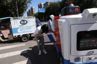 Autonomous delivery vehicle by JD Logistics operates on a street in Beijing